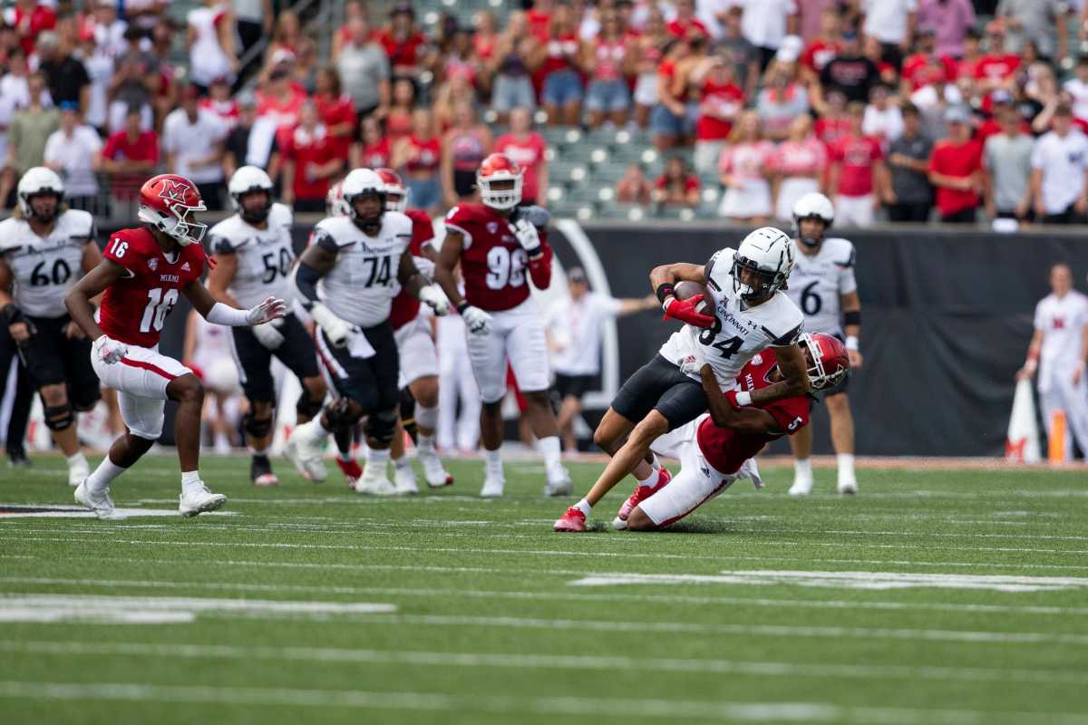 Miami (Oh) Redhawks defensive back John Saunders Jr. (5) takes down Cincinnati Bearcats wide receiver Nick Mardner (84) during the fourth quarter of the NCAA football game between the Cincinnati Bearcats and the Miami RedHawks at Paycor Stadium in Cincinnati on Saturday, Sept. 17, 2022. Cincinnati Bearcats Football Vs Miami Redhawks Sept 17 2022